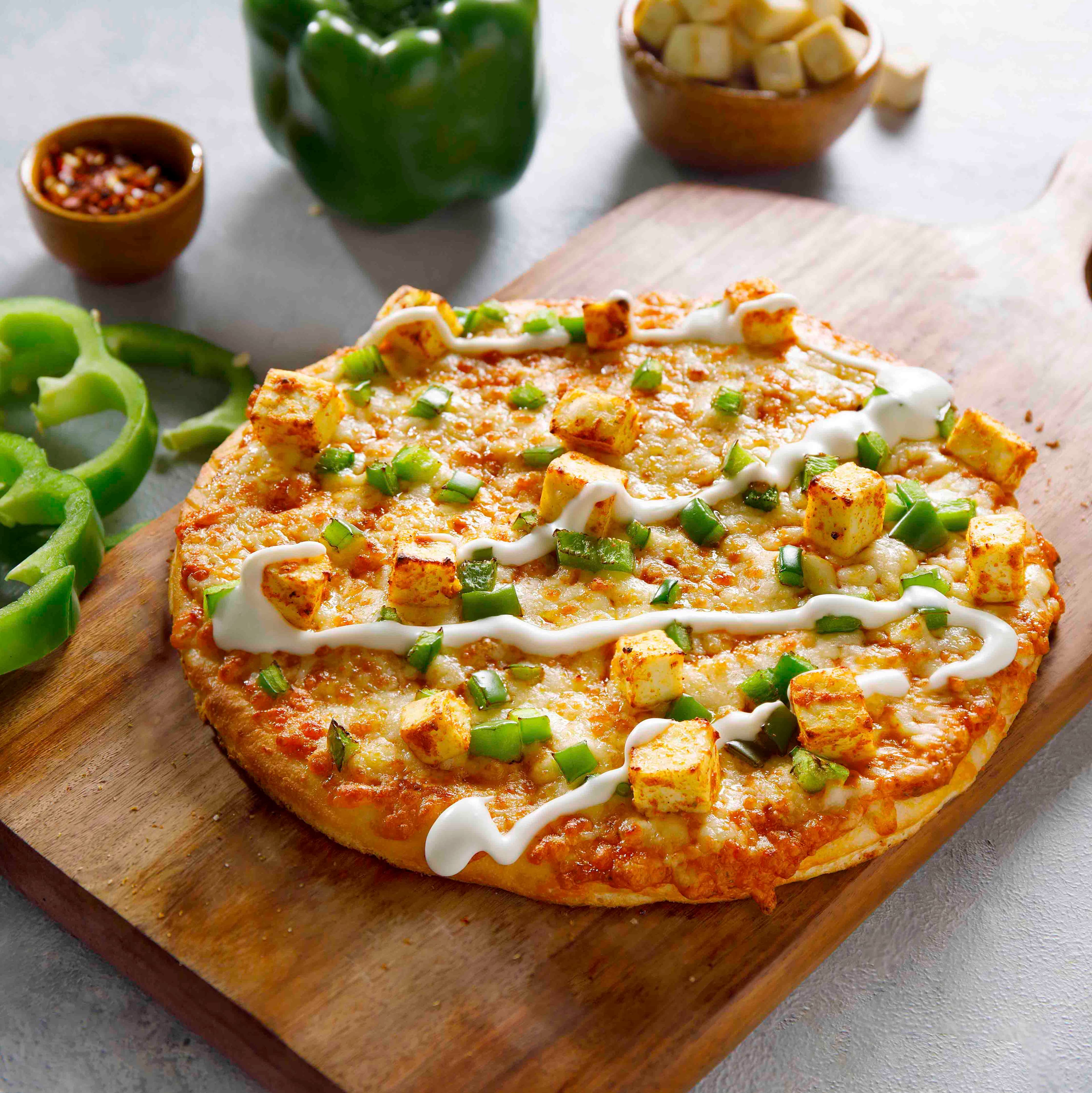 Paneer pizza with capsicum and melted cheese